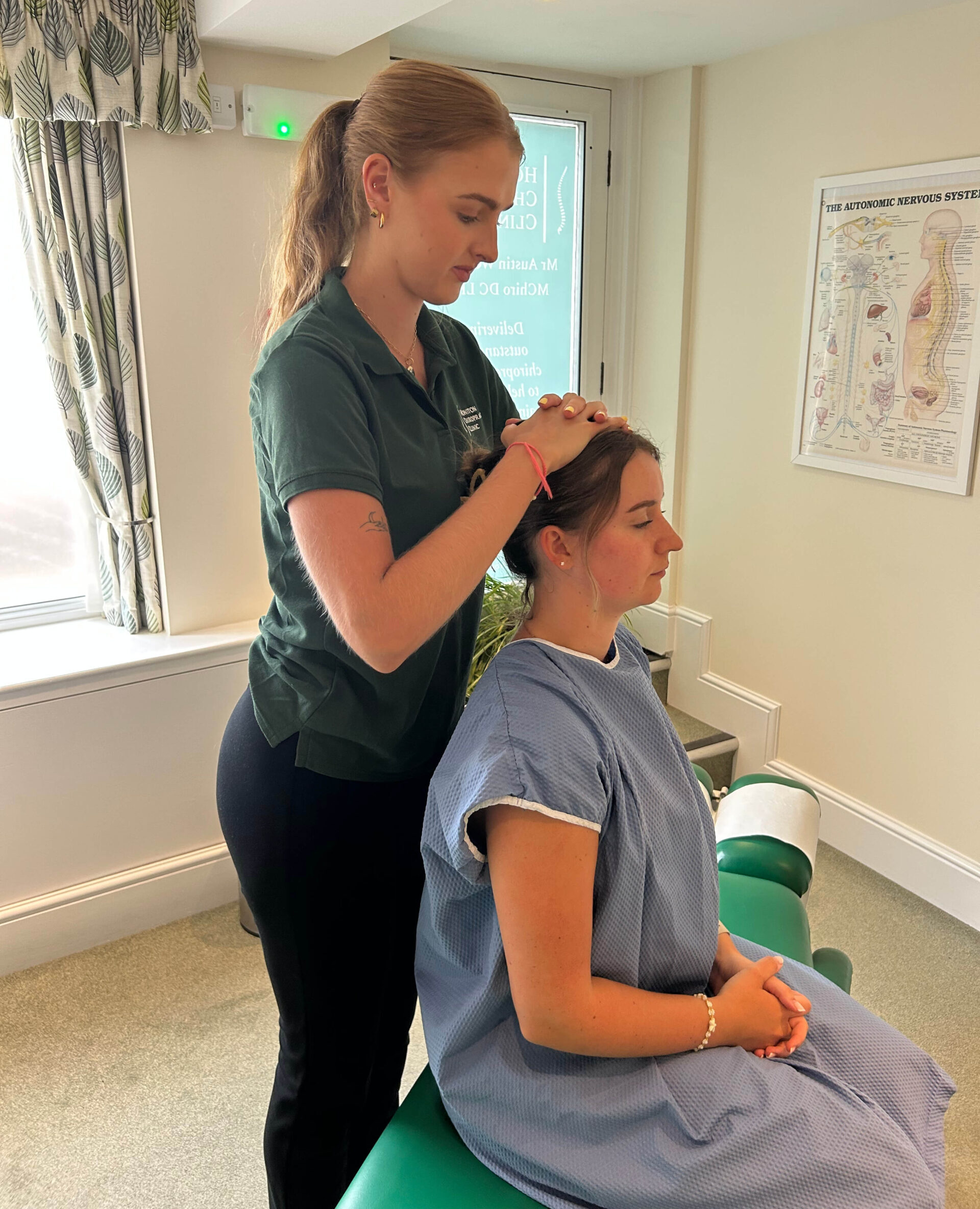 Neck adjustment by female chiropractor